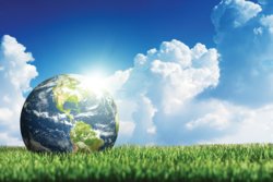 SSR Graphic: Image of the planet Earth sitting in a grassy field.